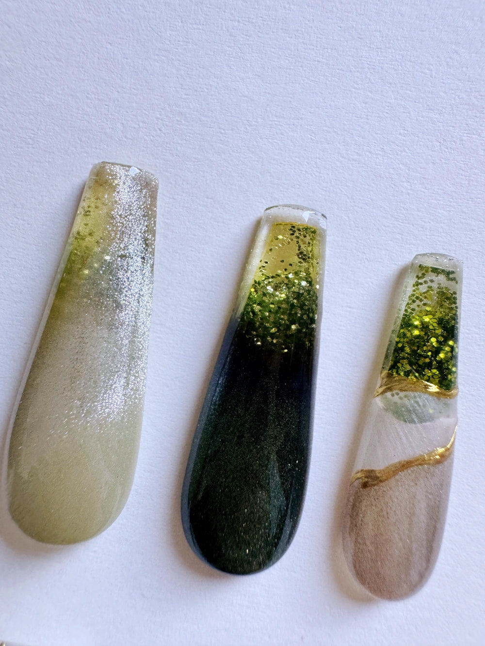 Emerald Pool Hand Drawn Elaborate Satin Gold Outline Emerald Cat Eye Flowing Sand Nail Art